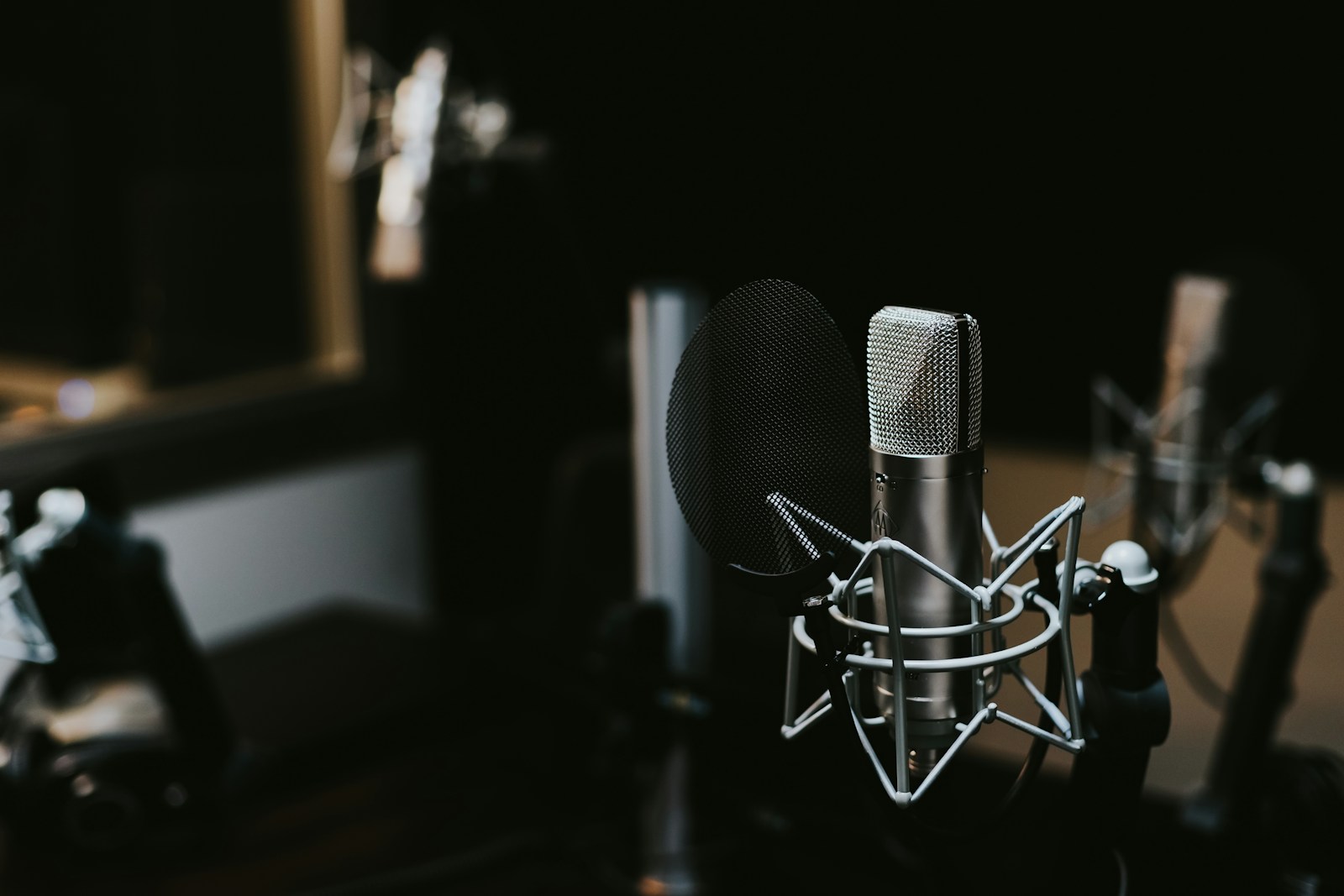 Studio microphone with a pop filter for podcast recording